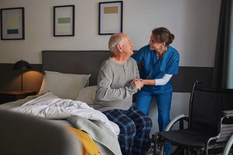 Older adult and family member reviewing medications and a daily care checklist at a kitchen table.